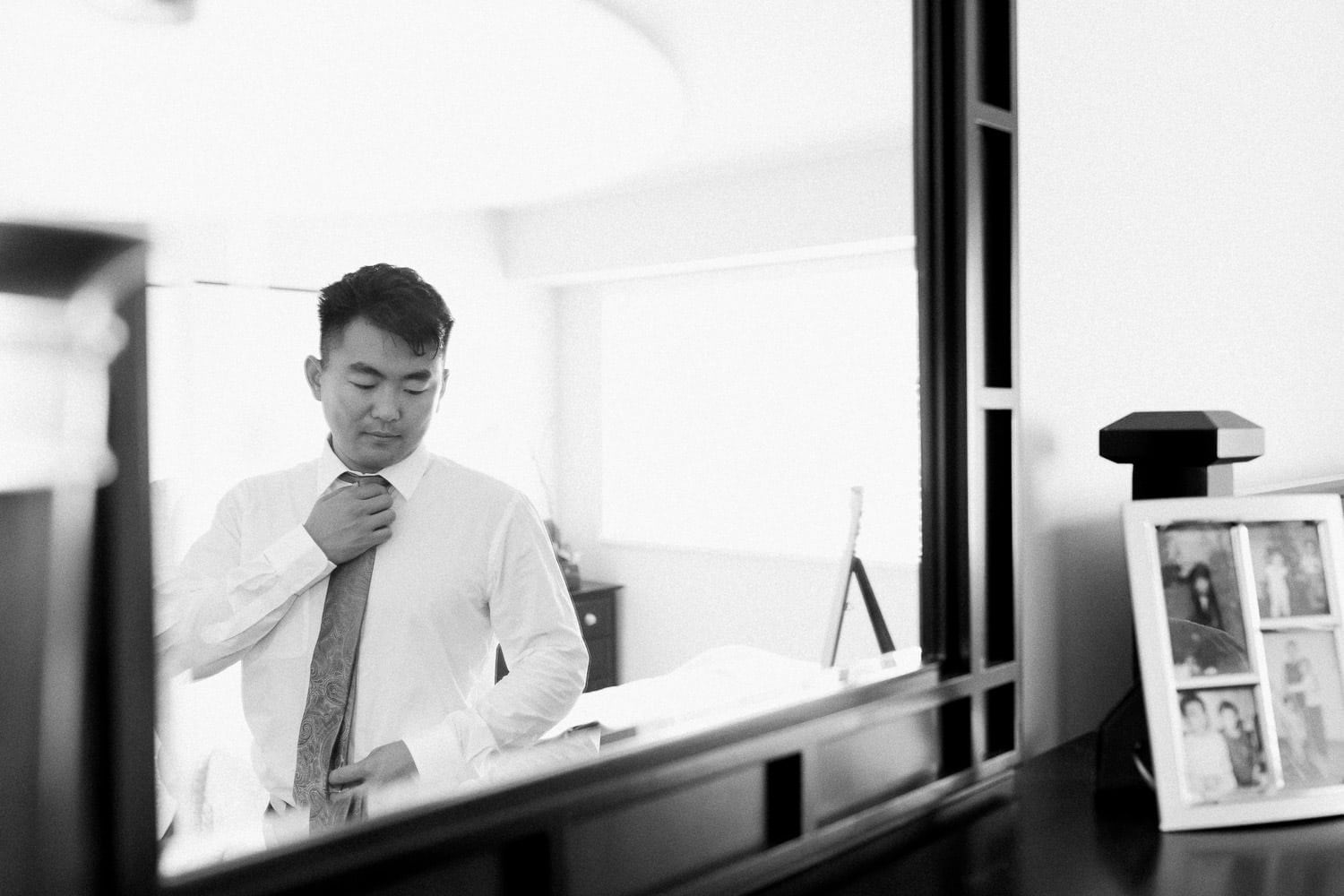 Groom during morning prep in front of the mirror | Vancouver wedding photographer | Westwood Plateau Golf Club Wedding
