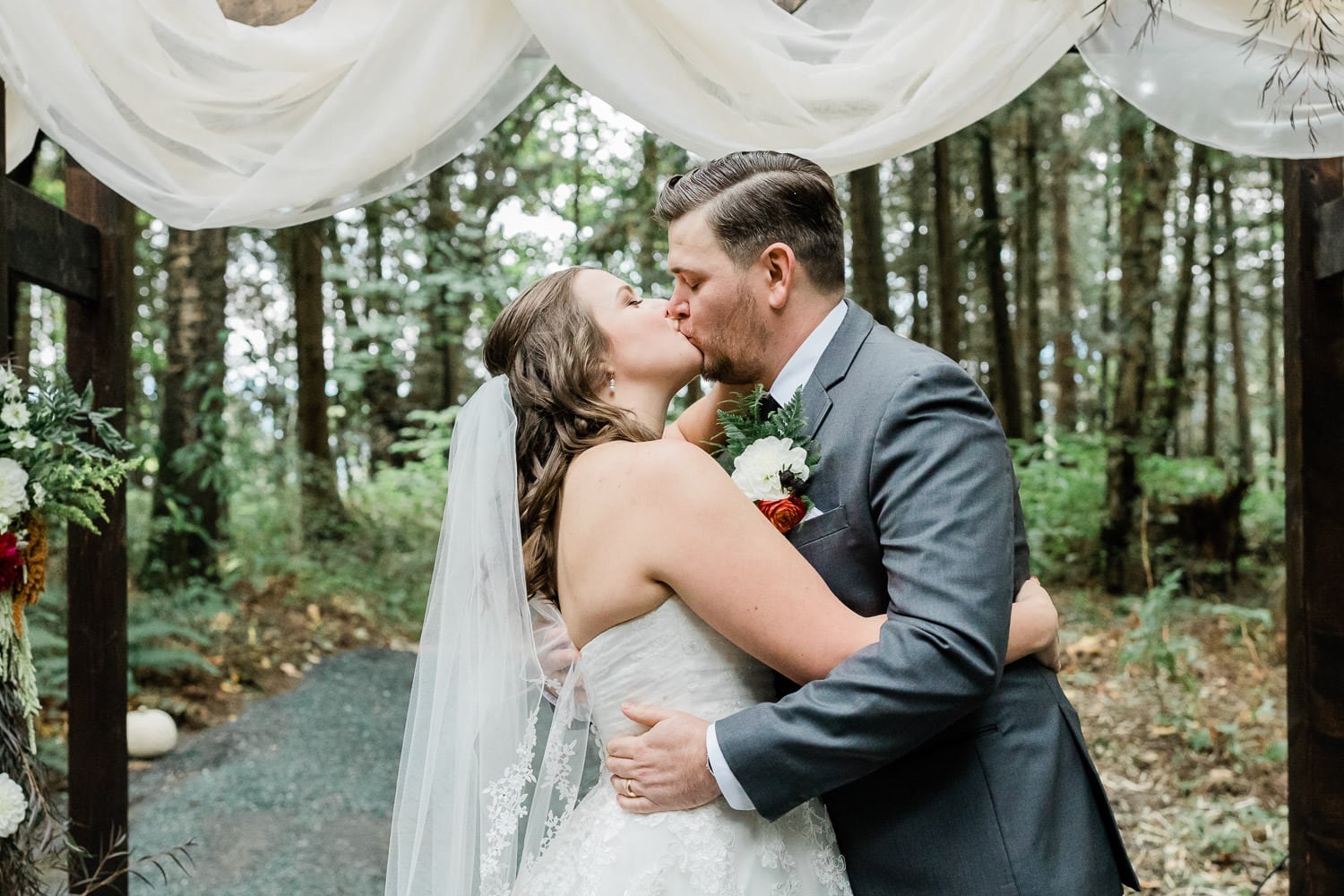 Rustic wedding ceremony photo in Langley and first kiss | Vancouver wedding photographer