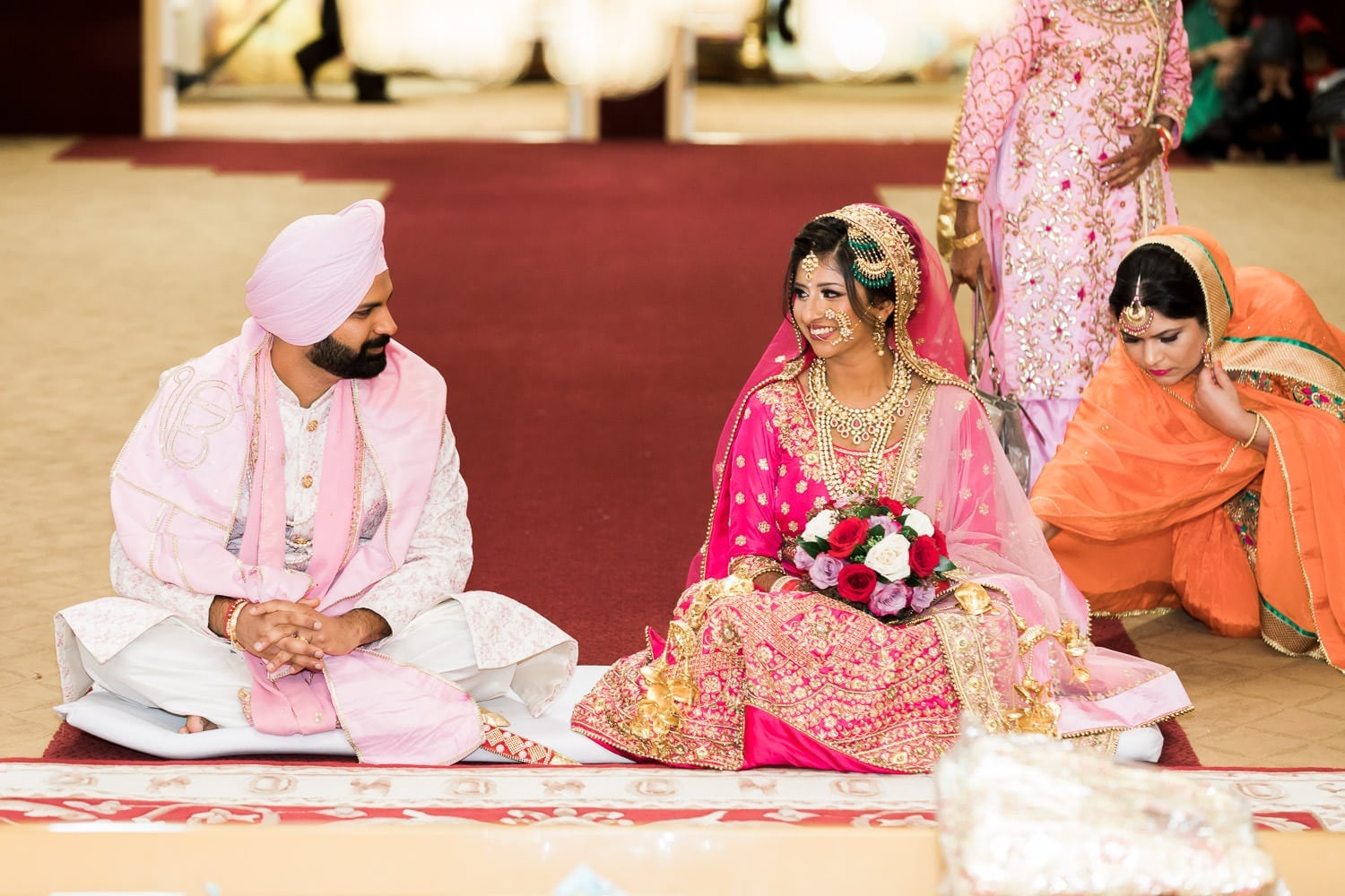 Indian bride and groom smiling at each other at the temple | Indian wedding photography Vancouver