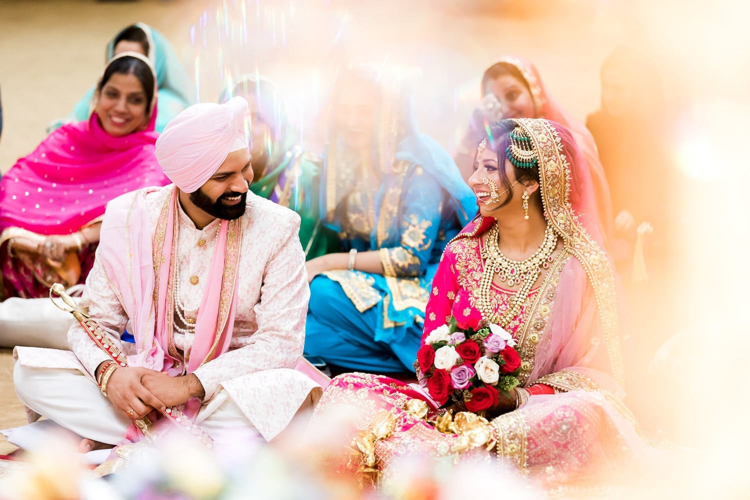 Indian bride and groom smiling at each other at the temple, Gurdwara Nanak Niwas | Indian wedding photography Vancouver