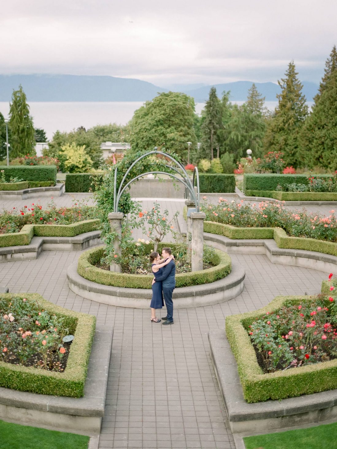 A couple holding hands during engagement photo session at UBC Rose Garden by wedding photographer in Vancouver