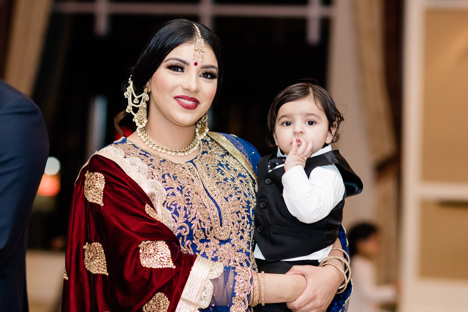 Indian bride holding a baby at the first Lohri